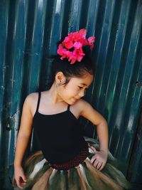 Cute girl posing against corrugated iron