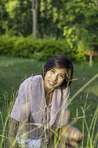 Portrait of smiling young woman on field