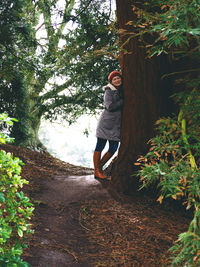 Side view of young woman in forest