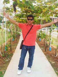 Portrait of man standing by plants