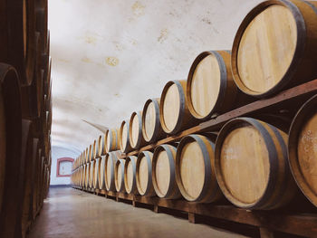 Full frame shot of a cellar filled with arranged barrels of wine