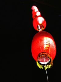 Low angle view of illuminated lantern hanging at night
