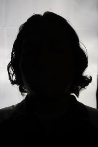 Close-up portrait of silhouette woman at home