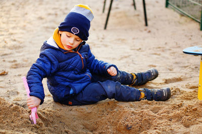 High angle view of boy playing on sand