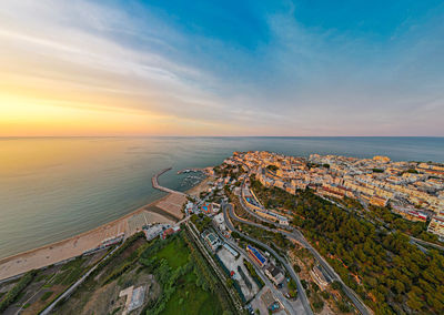 High angle view of sea and buildings against sky