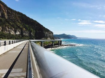 View of road by sea against sky