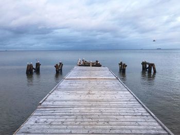 Pier on sea against sky