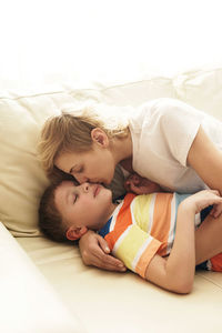 Cute baby boy sleeping on bed at home