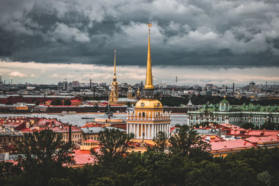 View of cityscape against cloudy sky