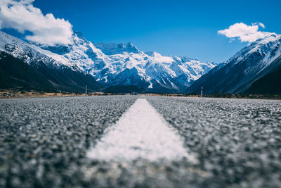 Surface level of snowcapped mountains against sky