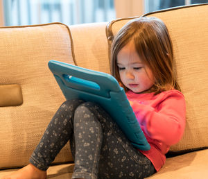 Girl sitting on sofa