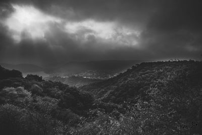 Scenic view of sea and mountains against sky