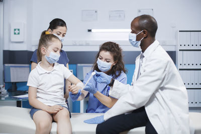 Portrait of female friends using digital tablet in clinic