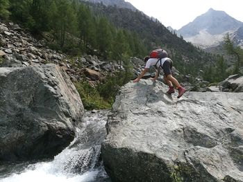 Man surfing on rocks at mountain