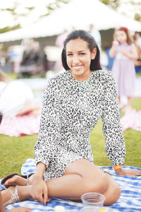 Portrait of a smiling young woman sitting outdoors