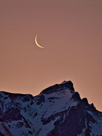 Scenic view of snowcapped mountains against sky during sunrise