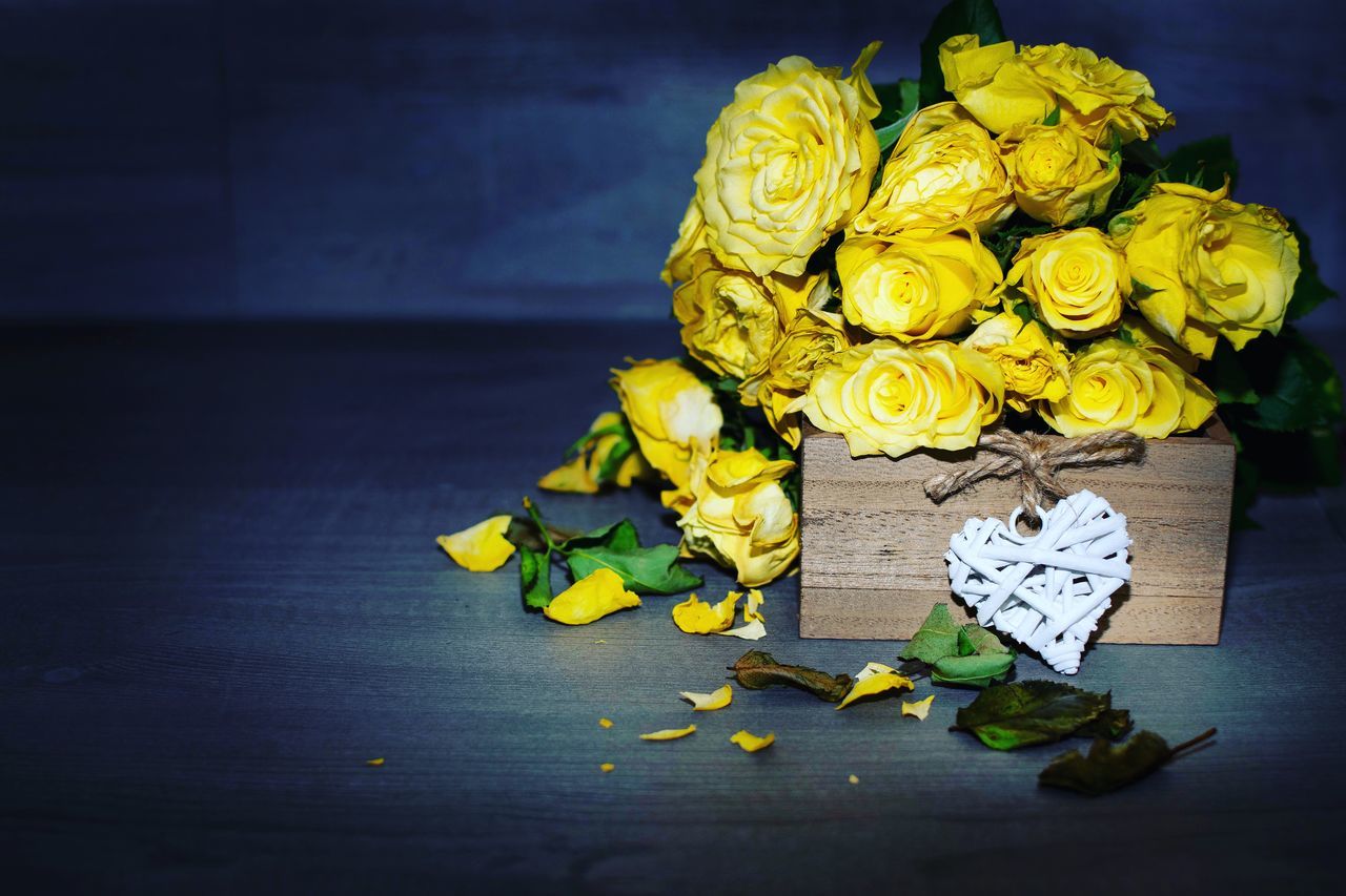 flower, flowering plant, plant, yellow, freshness, indoors, beauty in nature, rose, close-up, rose - flower, no people, nature, table, petal, flower head, flower arrangement, vulnerability, inflorescence, fragility, bouquet, bunch of flowers