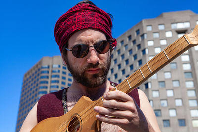 Portrait of man playing guitar