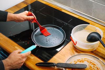 High angle view of person preparing pancakes at home in the kitchen