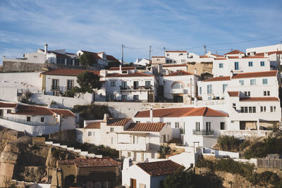 Buildings in town against sky