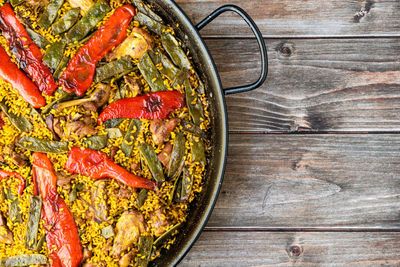 Paella, on wooden background