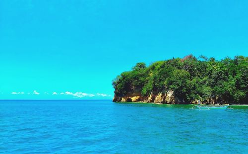 Scenic view of sea against clear blue sky