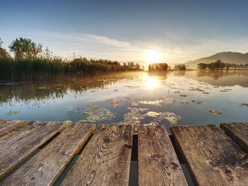 Scenic view of lake against sky during sunset