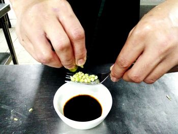 Cropped image of hand holding food