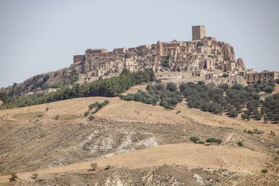 Rock formations on mountain against clear sky