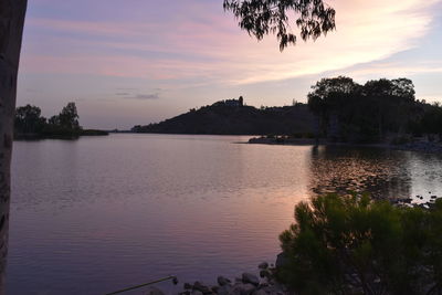 Scenic view of lake against sky at sunset