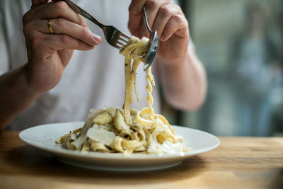 Midsection of man preparing food on table