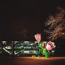 Illuminated tree against sky at night