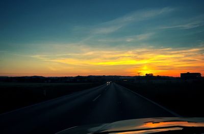 Close-up of car against sky during sunset