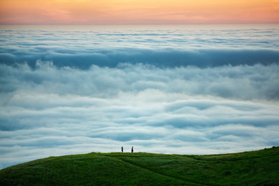 Scenic view of field against sky during sunset