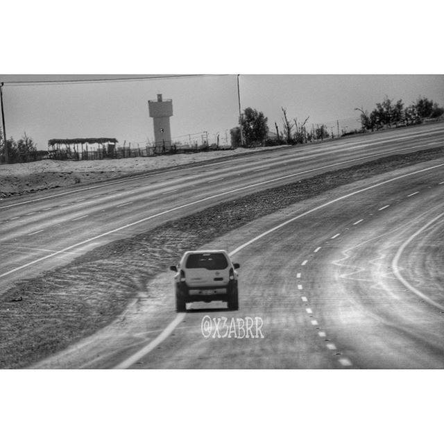 transfer print, transportation, road, auto post production filter, clear sky, land vehicle, road marking, car, street, copy space, landscape, sky, the way forward, mode of transport, field, outdoors, day, country road, empty, on the move