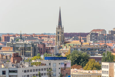 Buildings in city against clear sky