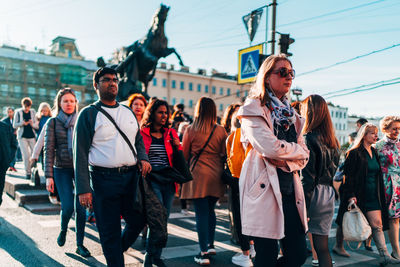 Group of people walking on street in city