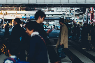 People walking on railroad station platform