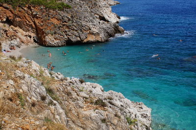 High angle view of cliff by sea against sky