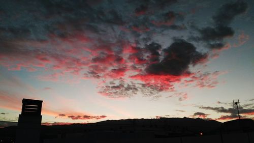 Low angle view of silhouette buildings against sky during sunset