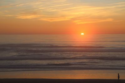 Scenic view of sea against orange sky