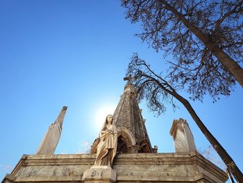 Low angle view of statue against clear blue sky