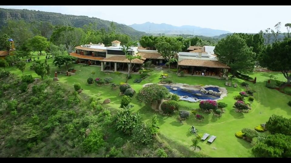 tree, building exterior, built structure, mountain, architecture, water, house, green color, village, scenics, high angle view, nature, tranquil scene, landscape, beauty in nature, tranquility, growth, hill, plant, clear sky