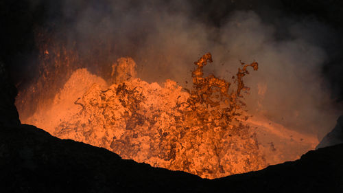 Close-up of volcanic against sky at night