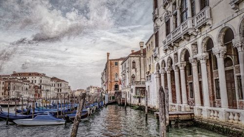 Boats in canal with buildings in background