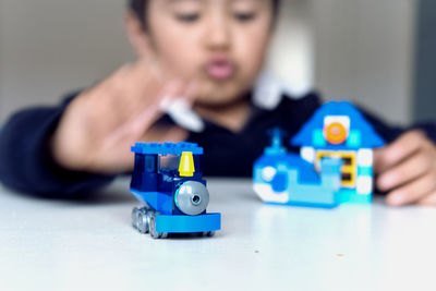 Boy playing with toy on table