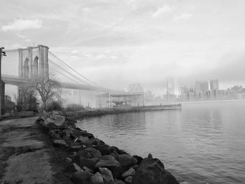 Bridge over river with city in background