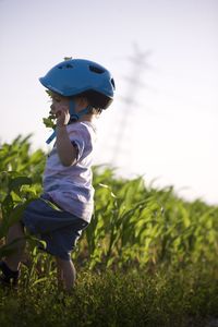 Side view of boy standing on field