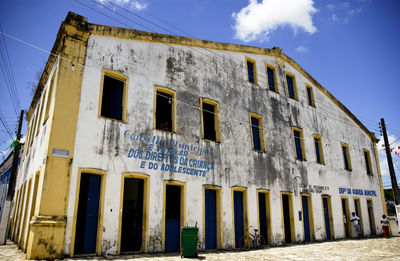 Low angle view of abandoned building against sky