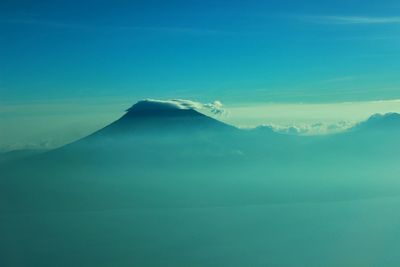 Scenic view of mountains against blue sky